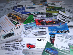 Dezenas de cartões e cartazes divulgam os carros clandestinos